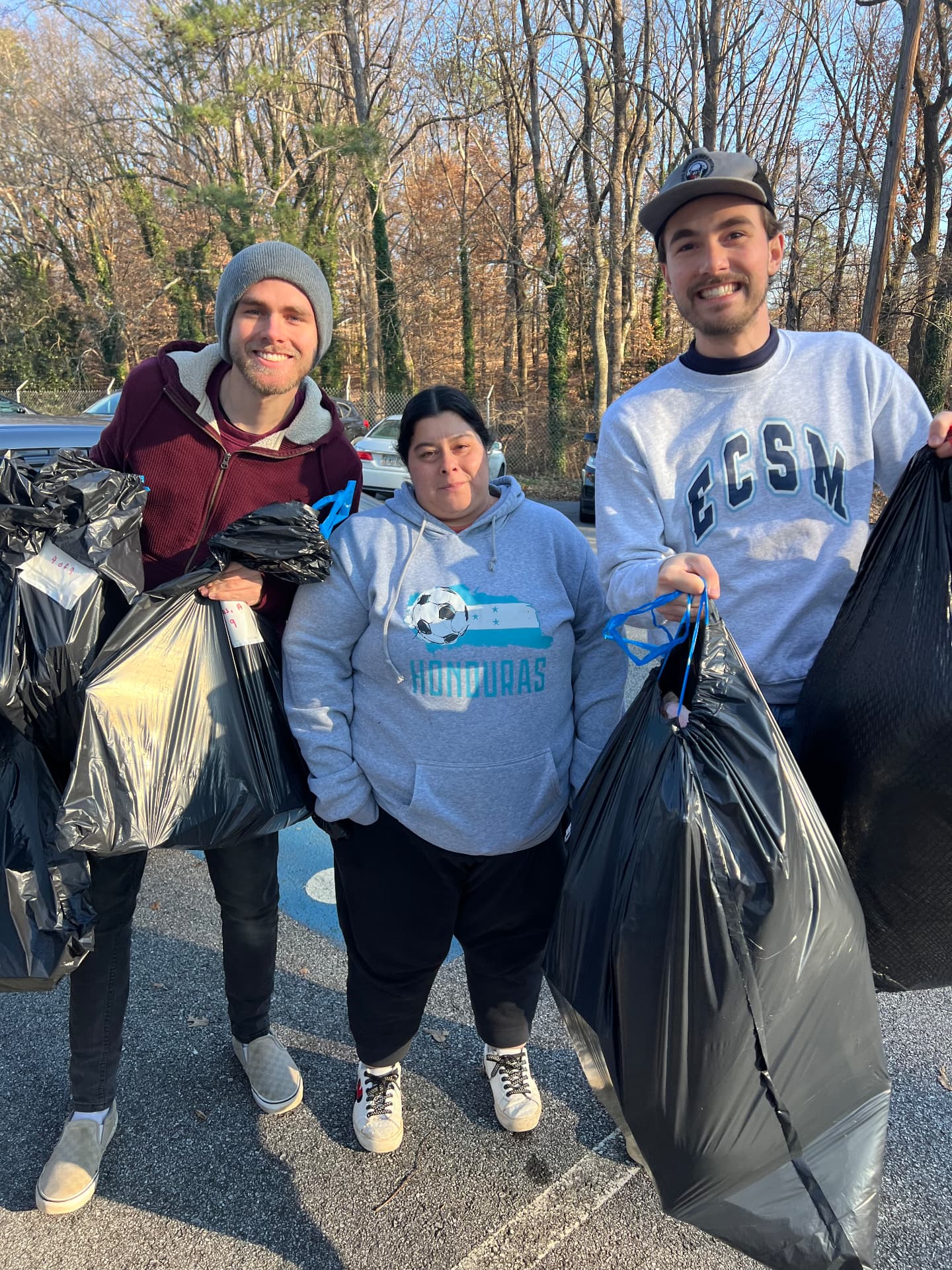 Volunteers carrying bags of Christmas gifts for Hope For The Family