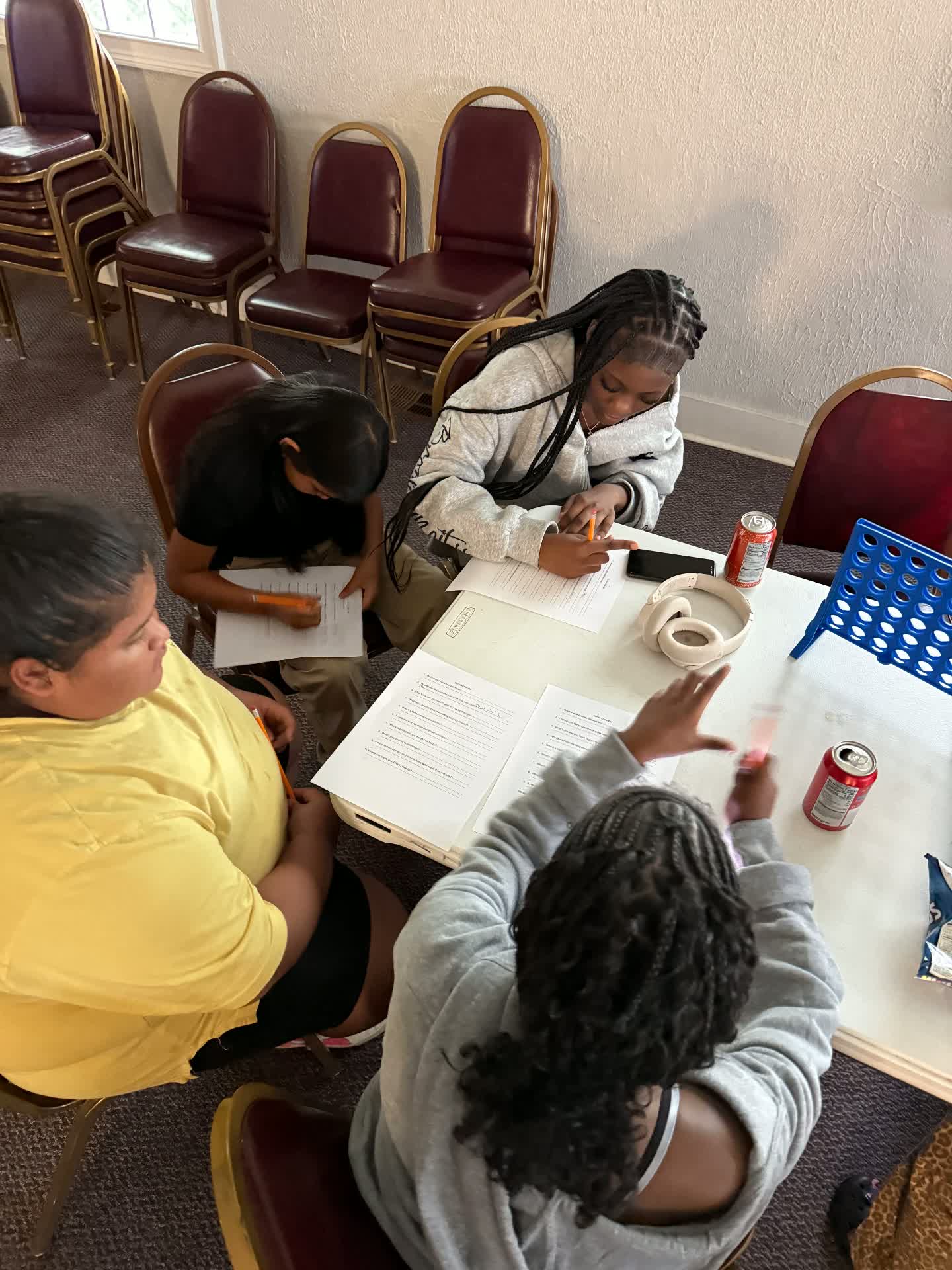 Teenagers in a small group circle with an adult leader at LIFT