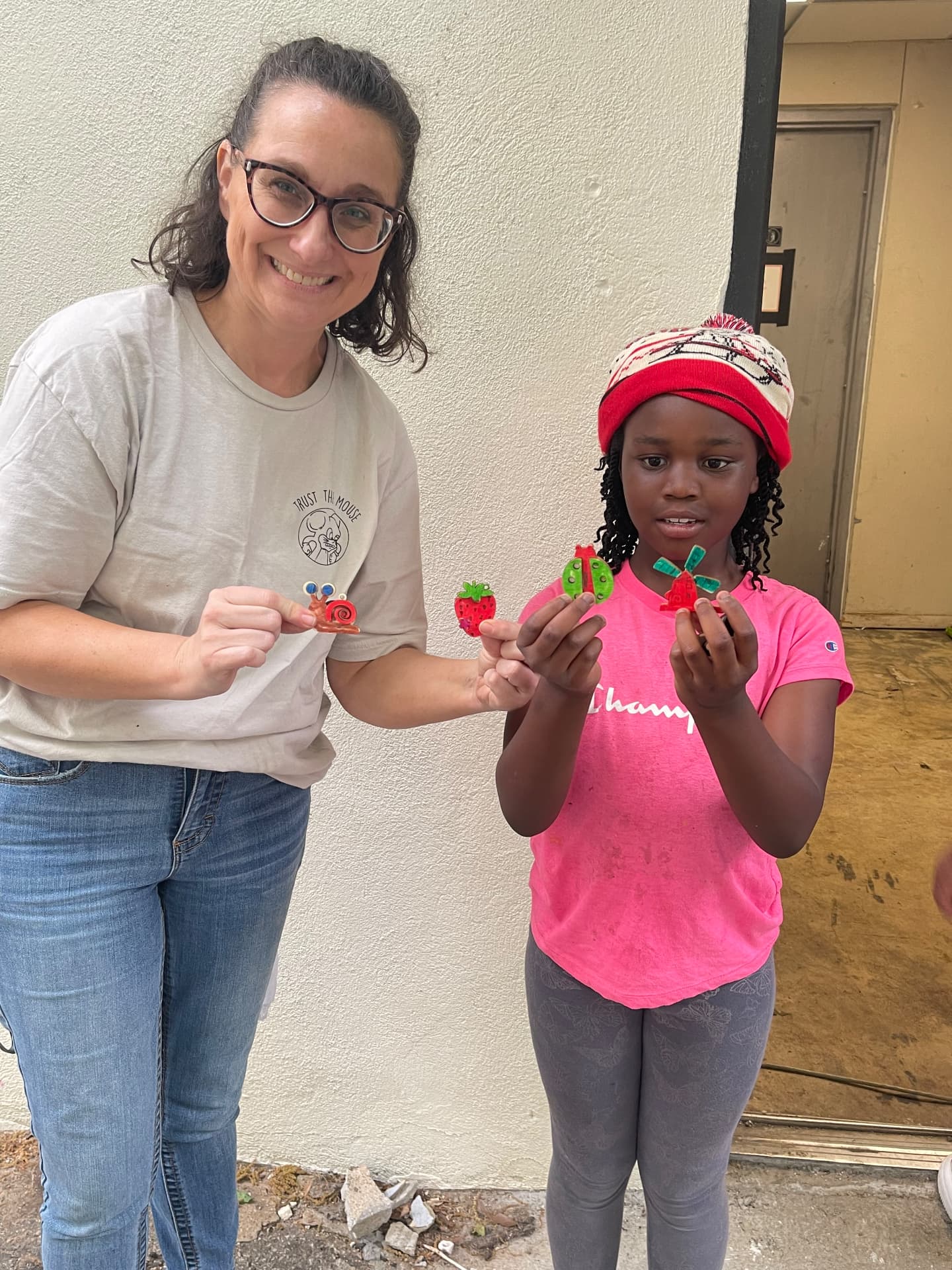 Partner volunteer helping a ThriveKids student with a craft project
