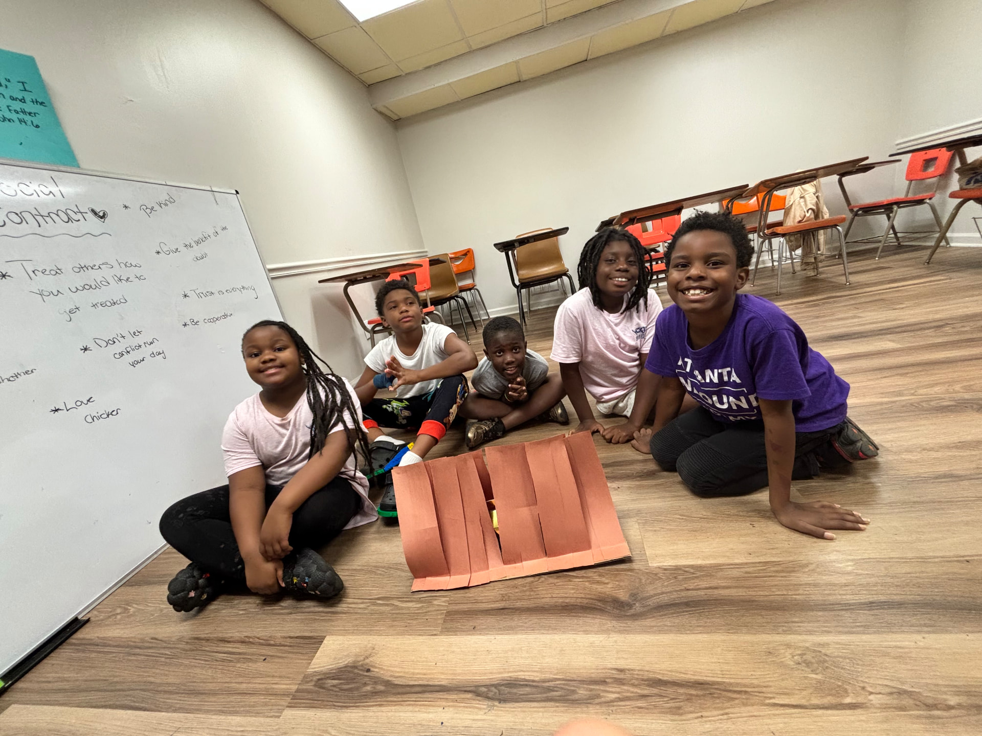 ThriveKids students showing off their craft projects