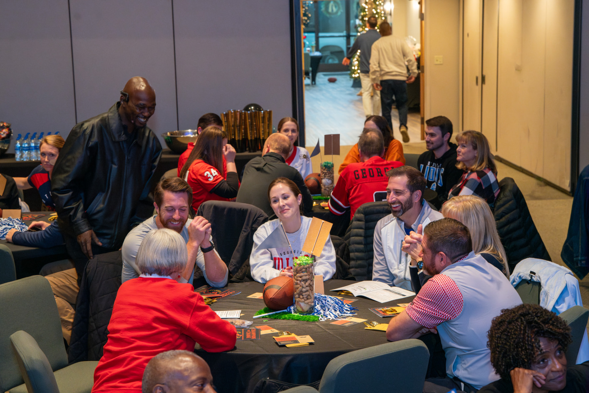 Guests talking around tables at a past AIM Victory Banquet