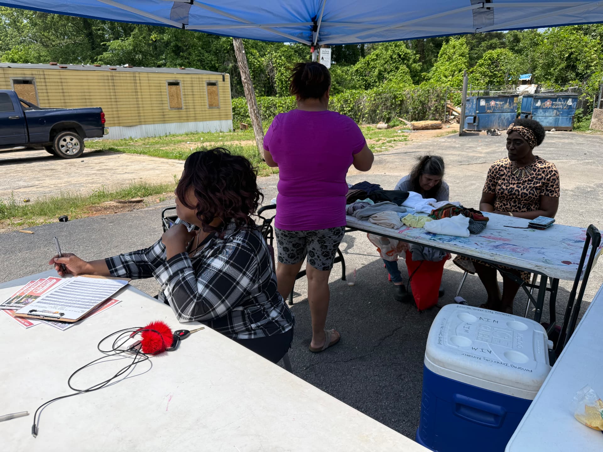 Neighbors signing in at the AIM mobile distribution tent
